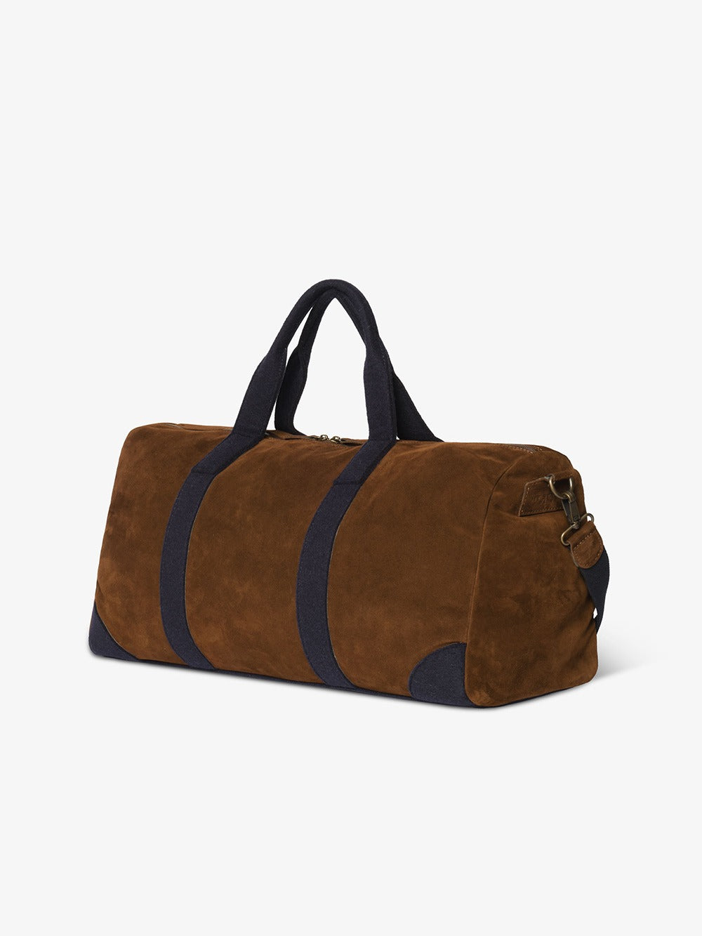 Three-quarter view of the duffle bag showing the side profile, barrel shape and metal hardware