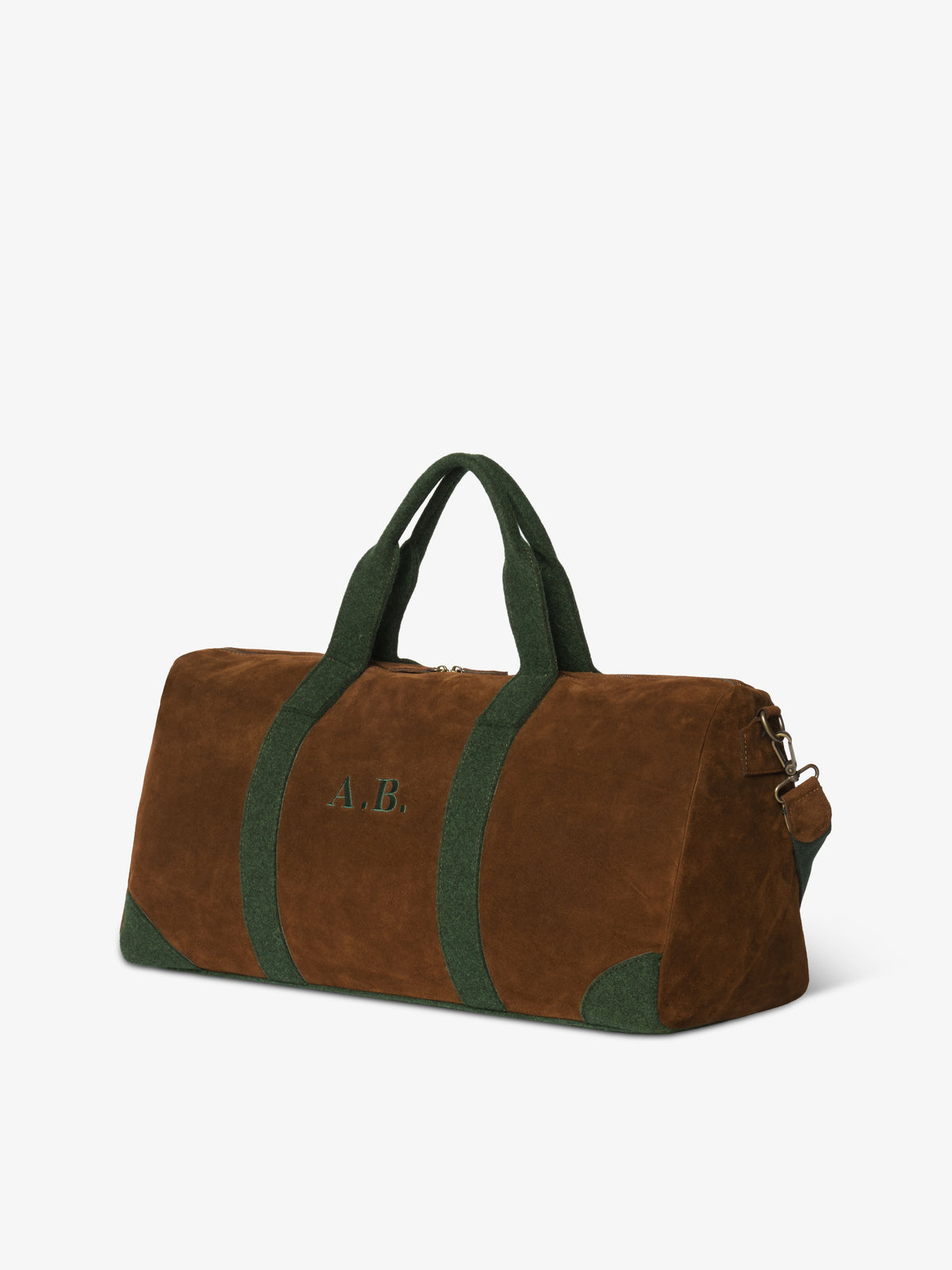Angled view of the brown suede duffle bag featuring embroidered monogram reading A.B