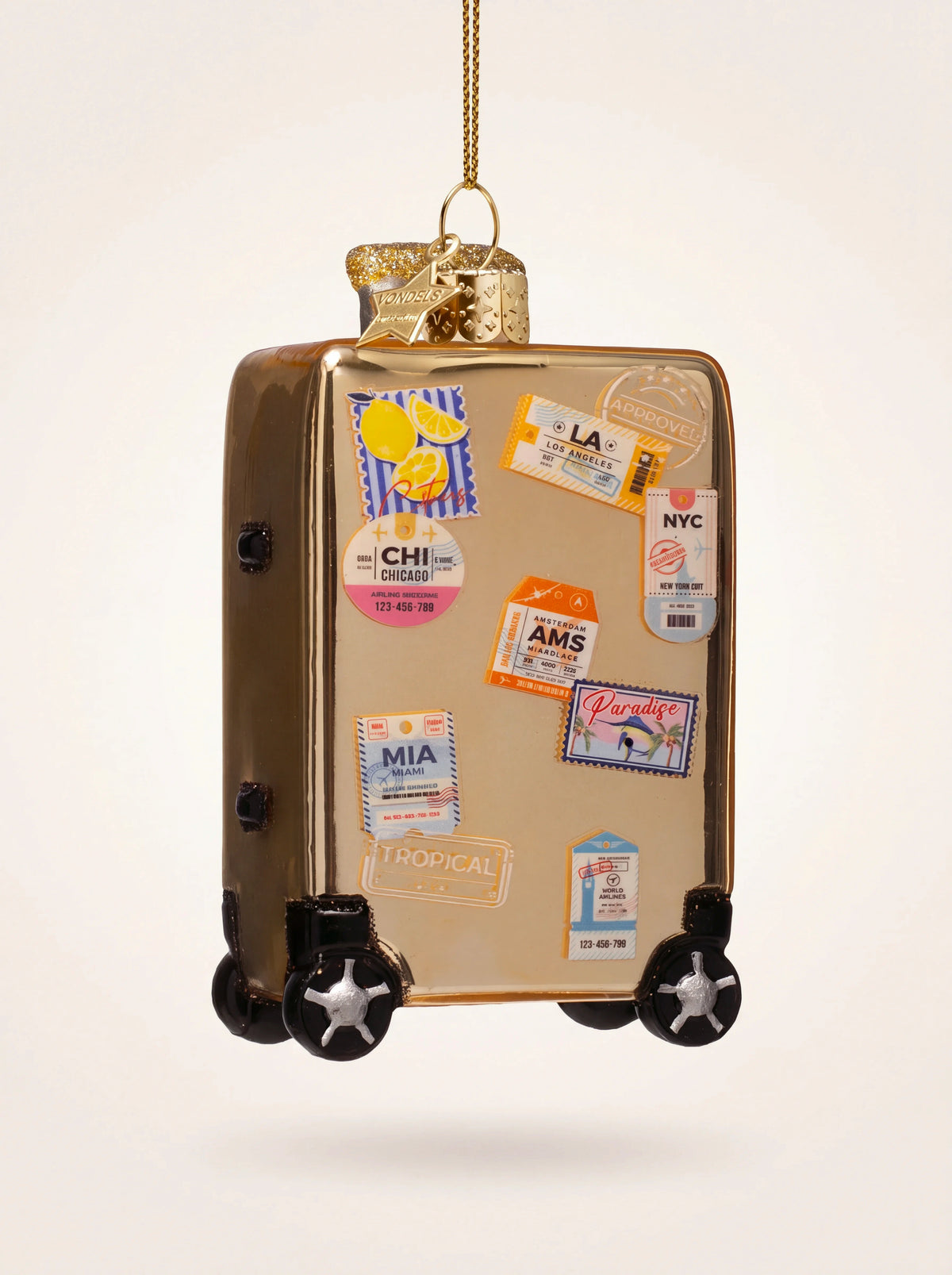 Gold glass suitcase Christmas ornament decorated with colourful travel stickers and black wheels