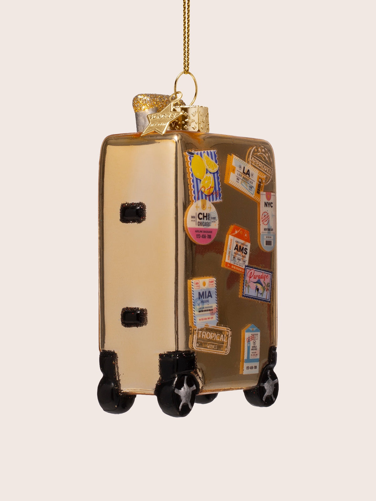 Three-quarter view of the gold glass suitcase ornament, showing its depth and glittery handle