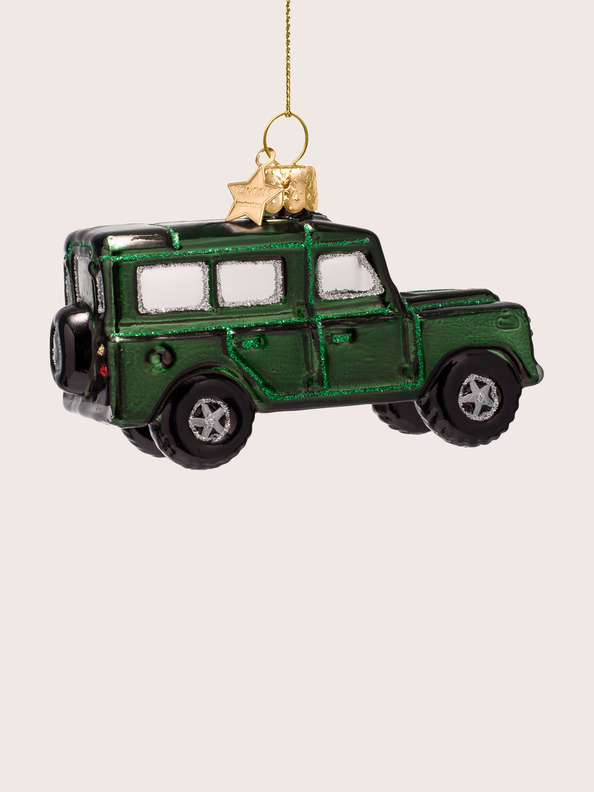 Side view of the green SUV ornament showing the side doors, black wheels and rear spare tyre