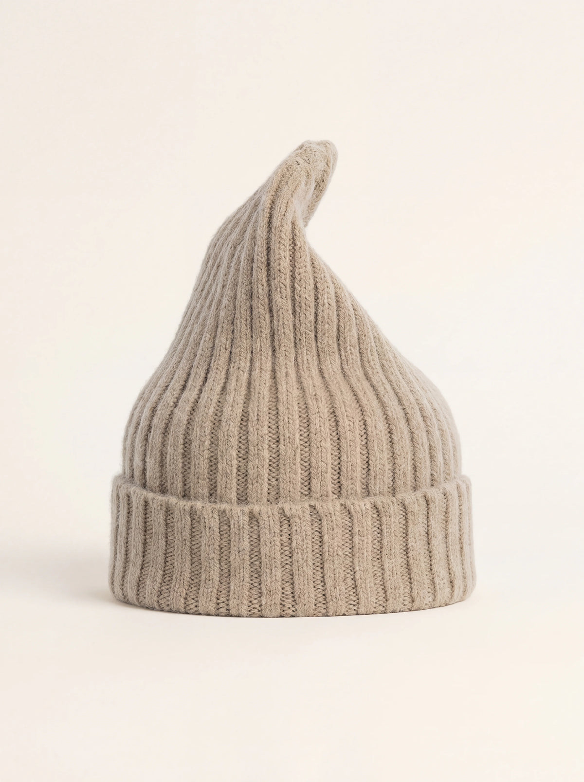 Tall ribbed wool beanie in clay beige with an elongated crown and wide folded cuff