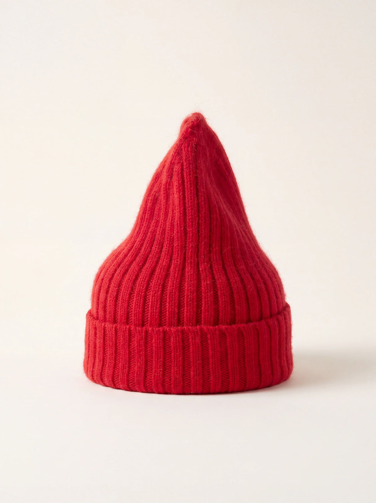 Crimson ribbed wool-blend beanie with a tall pointed crown and wide folded turn-up cuff