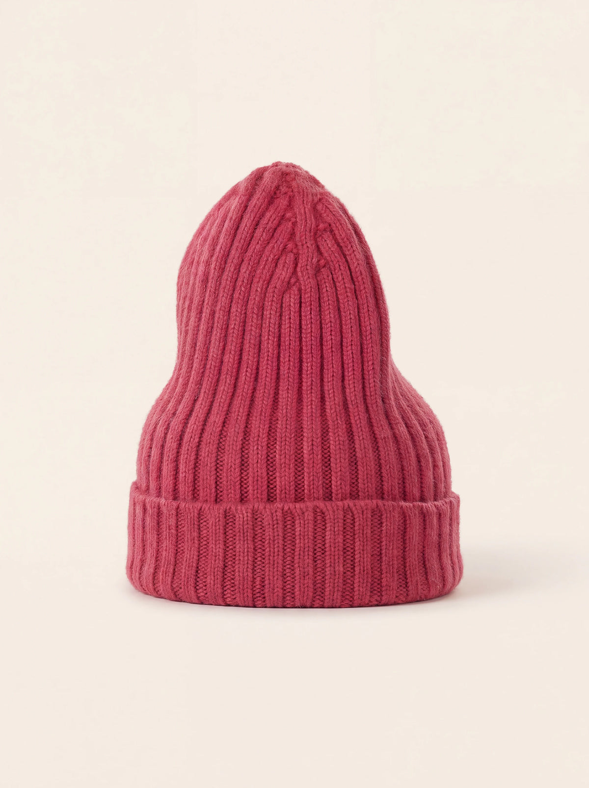 Fuchsia ribbed wool beanie with a folded turn-up cuff and a tall shaped crown