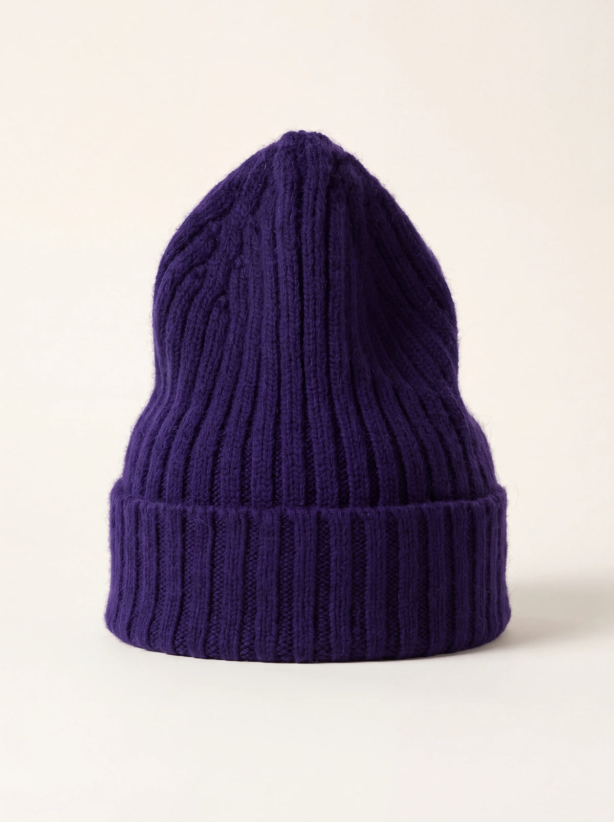 Tall ribbed wool beanie in deep indigo with a turned-up cuff