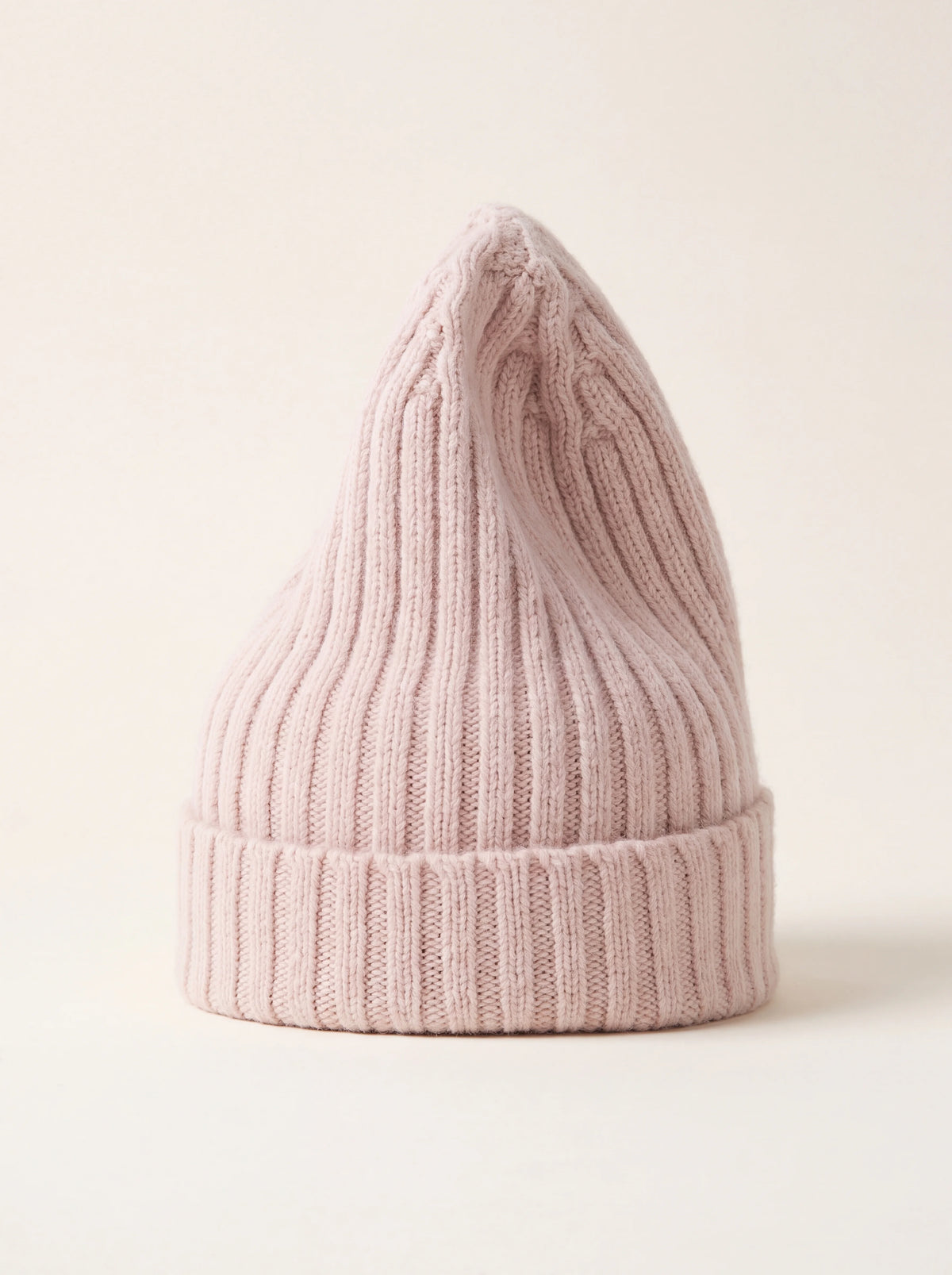 Tall ribbed wool beanie in misty rose pink with a folded turnover cuff