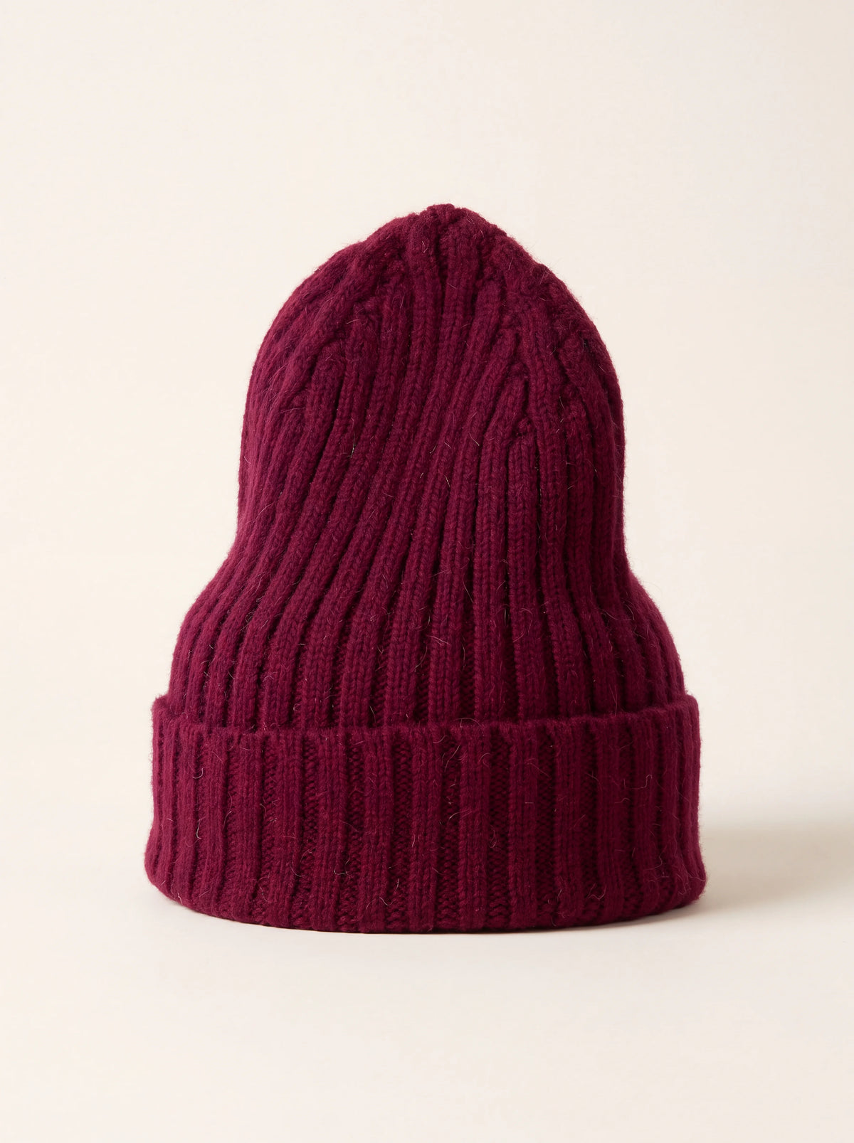 Wine red tall ribbed wool beanie with a wide folded cuff
