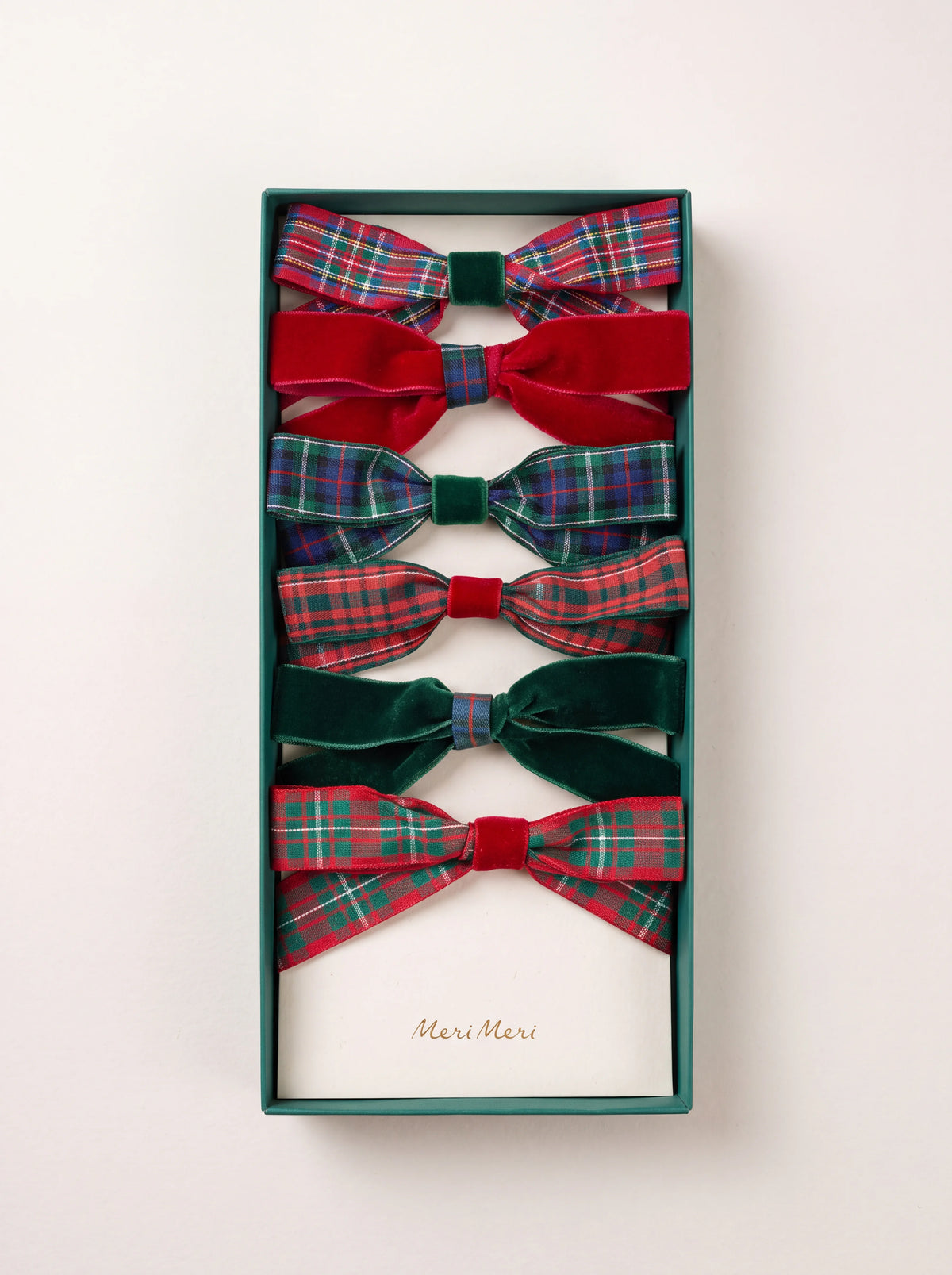 Set of six ribbon bow hair clips in green and red tartan and velvet with contrasting centre knots, in a box