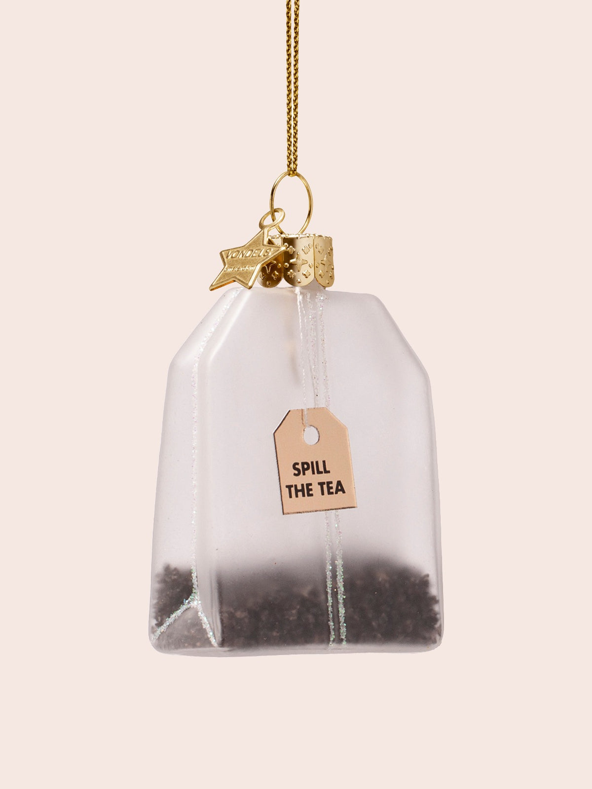 Reverse side of the tea bag ornament showing the tag reading SPILL THE TEA