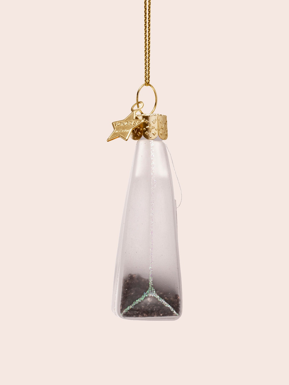 Side view of the tea bag ornament showing the tapered profile and glitter seam