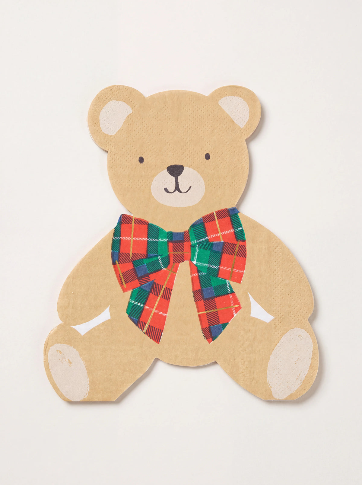 Paper napkin shaped like a seated teddy bear with a printed red, green and blue tartan bow tie