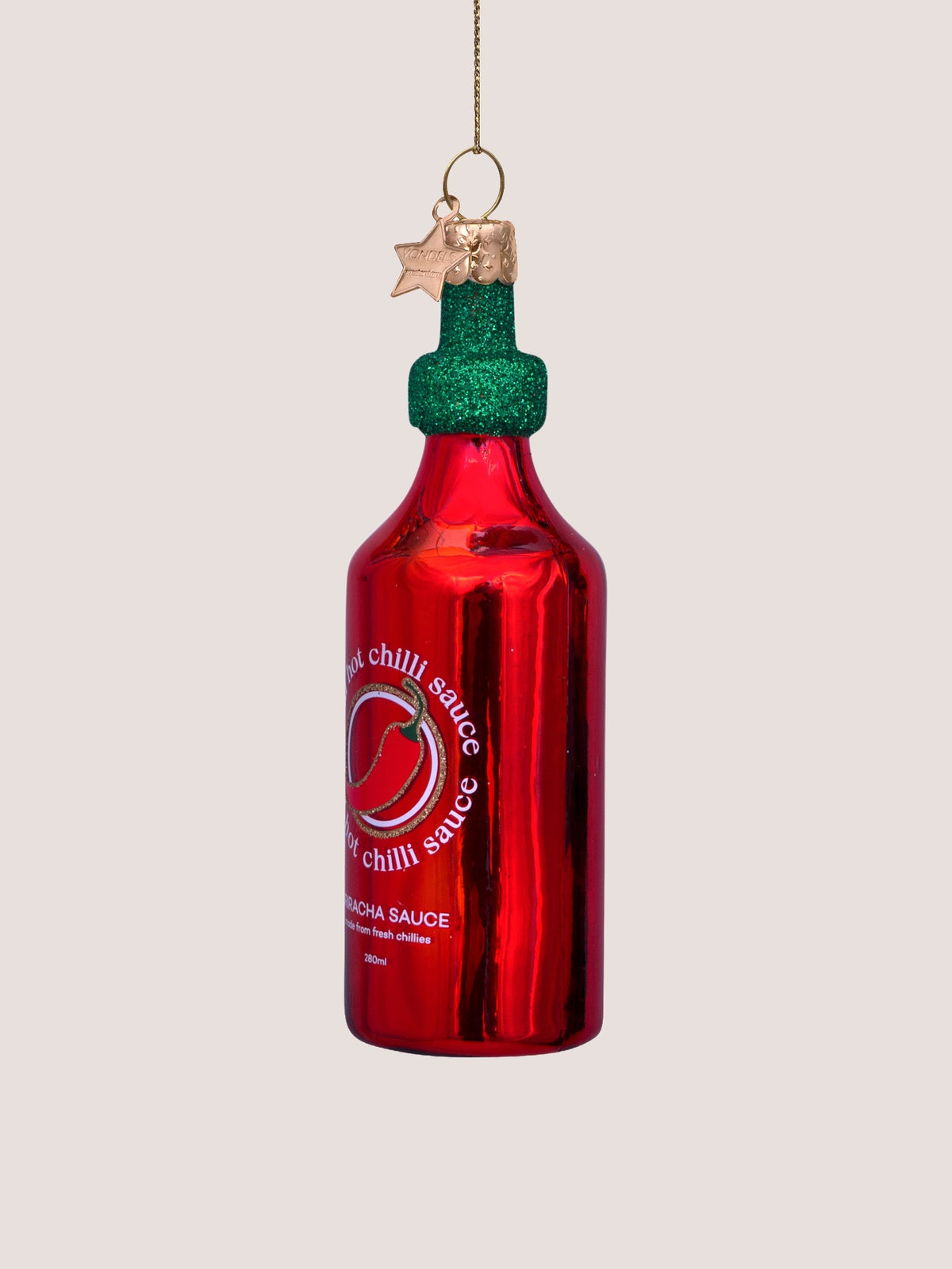 Three-quarter view of the chilli sauce bottle ornament showing its cylindrical profile
