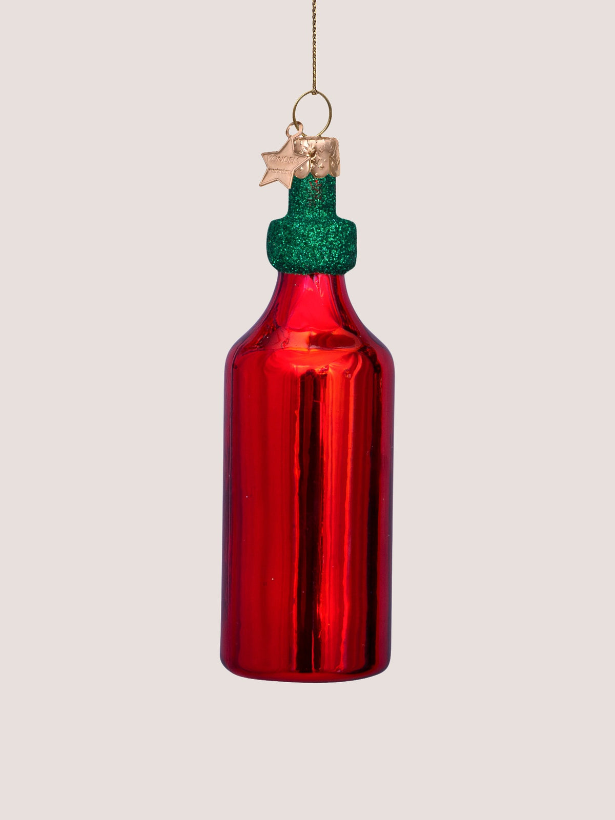 Reverse side of the glass bottle ornament showing the plain glossy red surface
