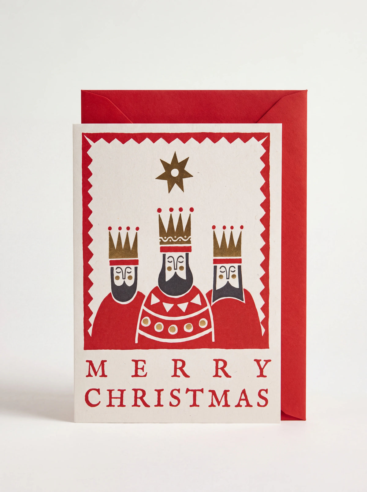 Christmas card illustrated with the Three Kings and 'MERRY CHRISTMAS' text, shown with a red envelope