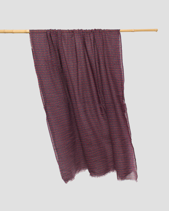 Navy wool scarf draped unfolded across a hanging rail, showing its full width and fringed hem