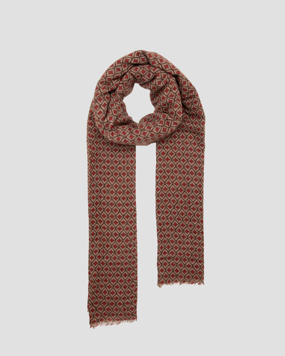 Wool scarf looped in a neck drape with a red and brown geometric diamond pattern and fringed ends