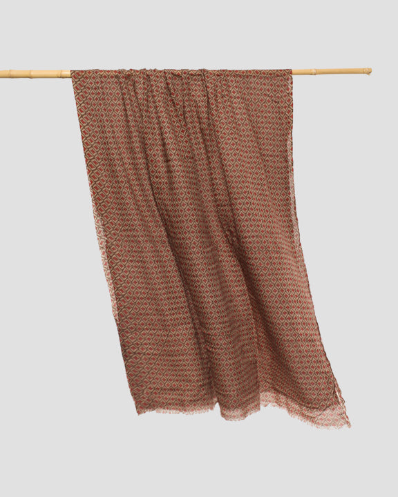 Rectangular wool scarf hung over a rail, showing its lightweight drape and delicate frayed hem