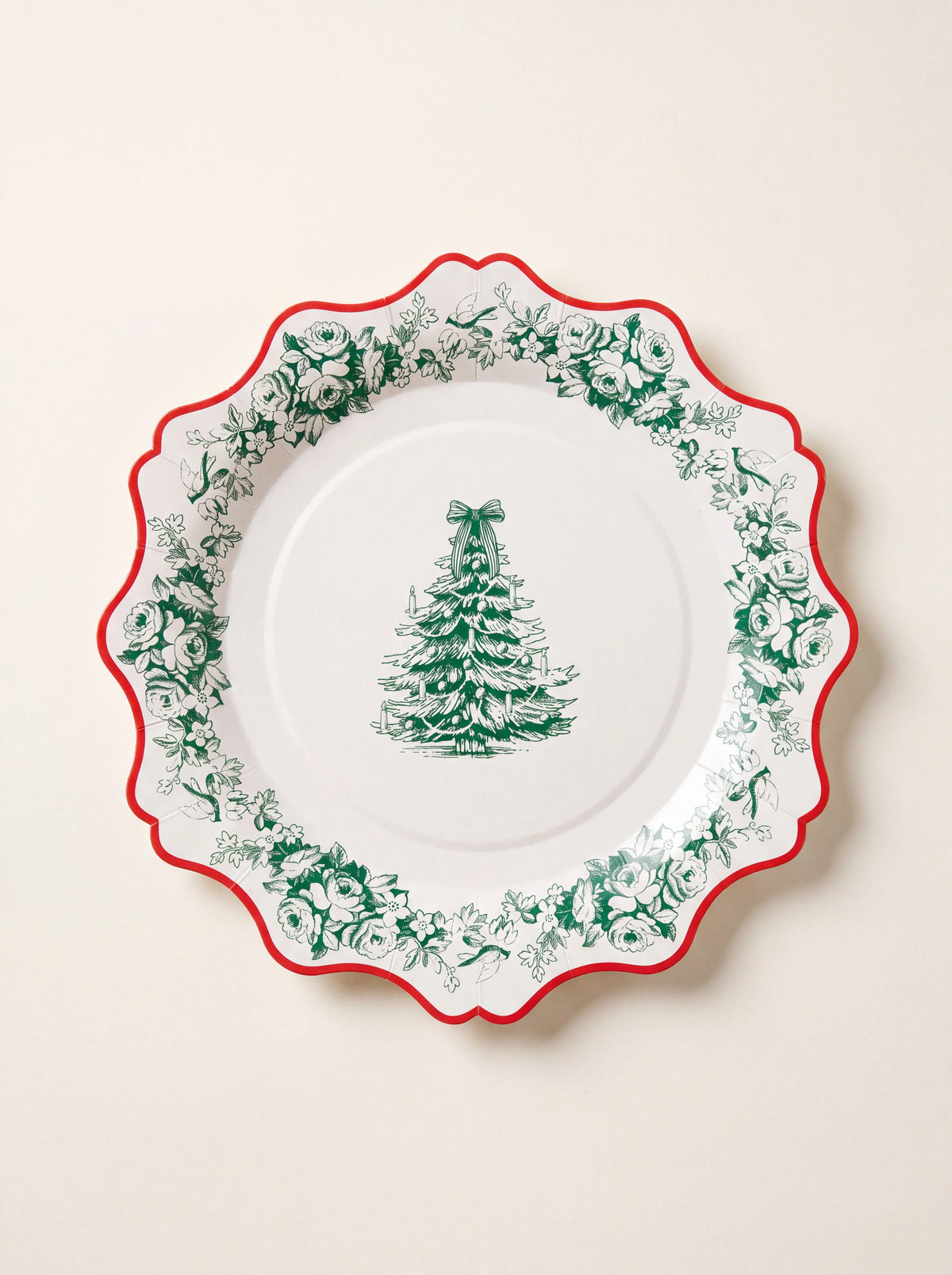 Scalloped paper plate with a red edge, green toile floral garland border, and central Christmas tree motif