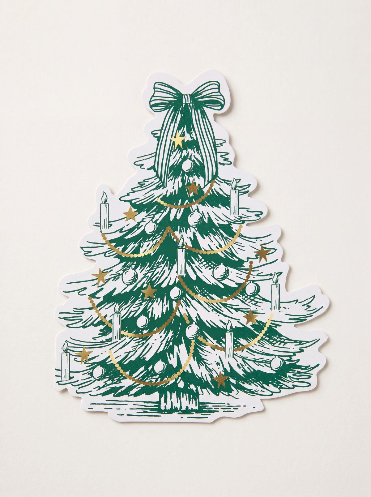 Paper napkin shaped like a Christmas tree with green illustration, bow topper and gold foil details