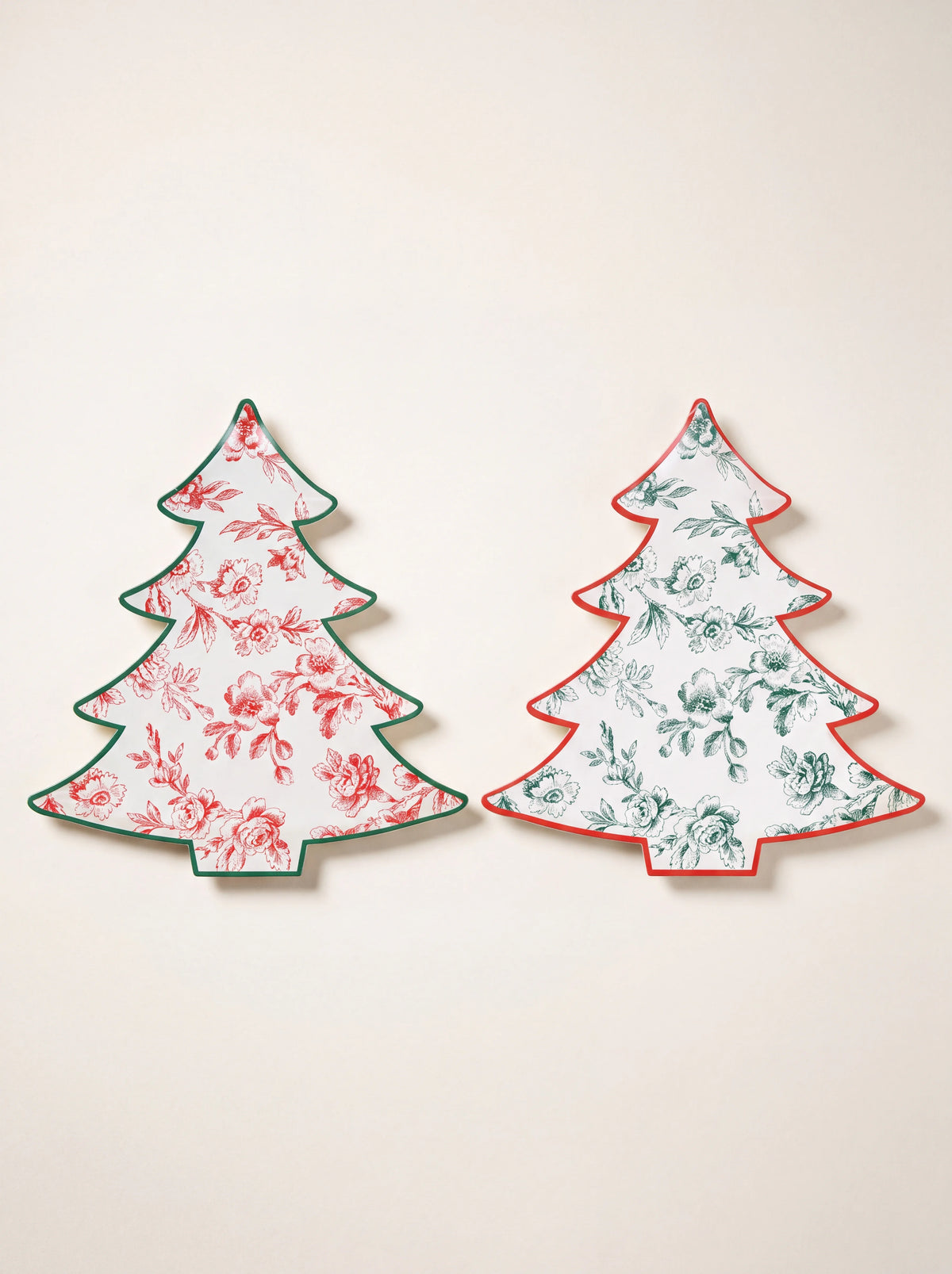 Christmas tree-shaped paper plates with red and green floral toile patterns and contrasting rims