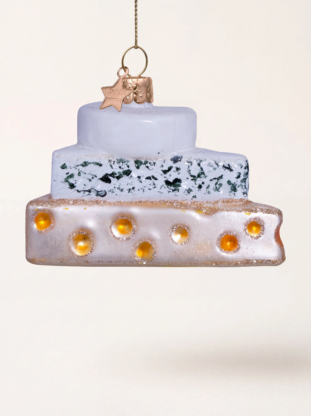 Glass Christmas ornament shaped like three stacked cheeses with hand-painted details and glitter trim