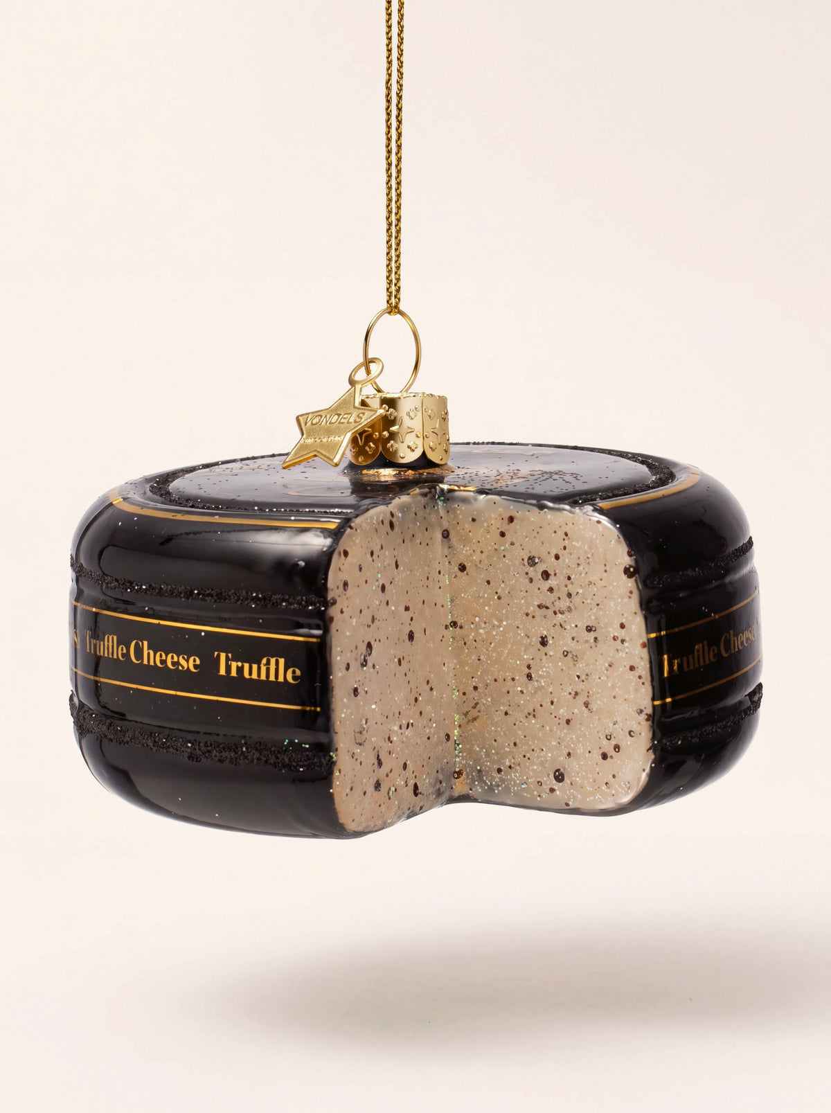 Truffle cheese glass ornament with a glossy black rind and a cut wedge showing a speckled interior