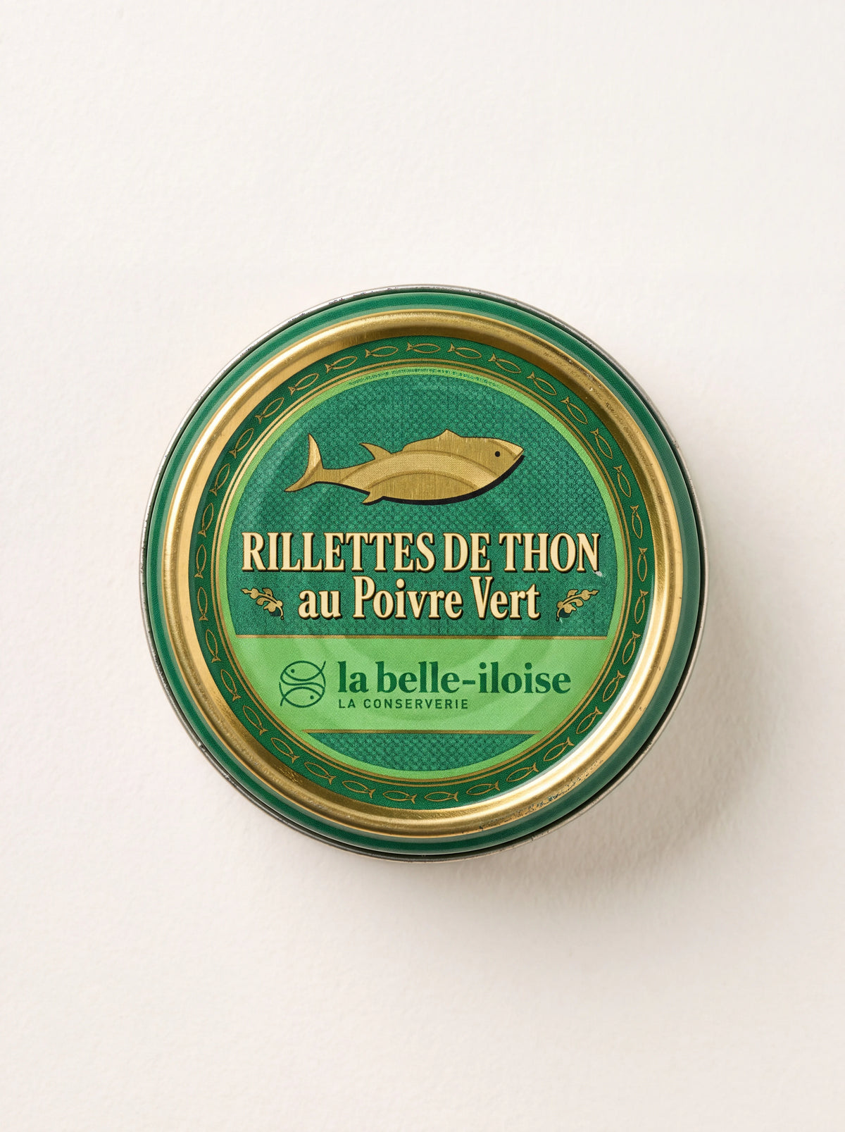 Round green and gold tin of tuna rillettes with green pepper, labelled Rillettes de Thon au Poivre Vert