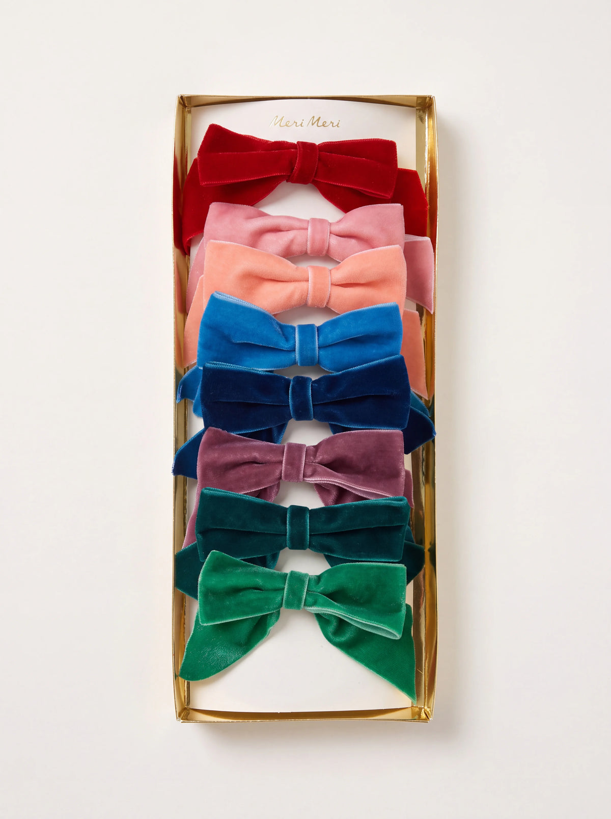 Set of eight cotton velvet bow hair clips in assorted colours displayed in a presentation box