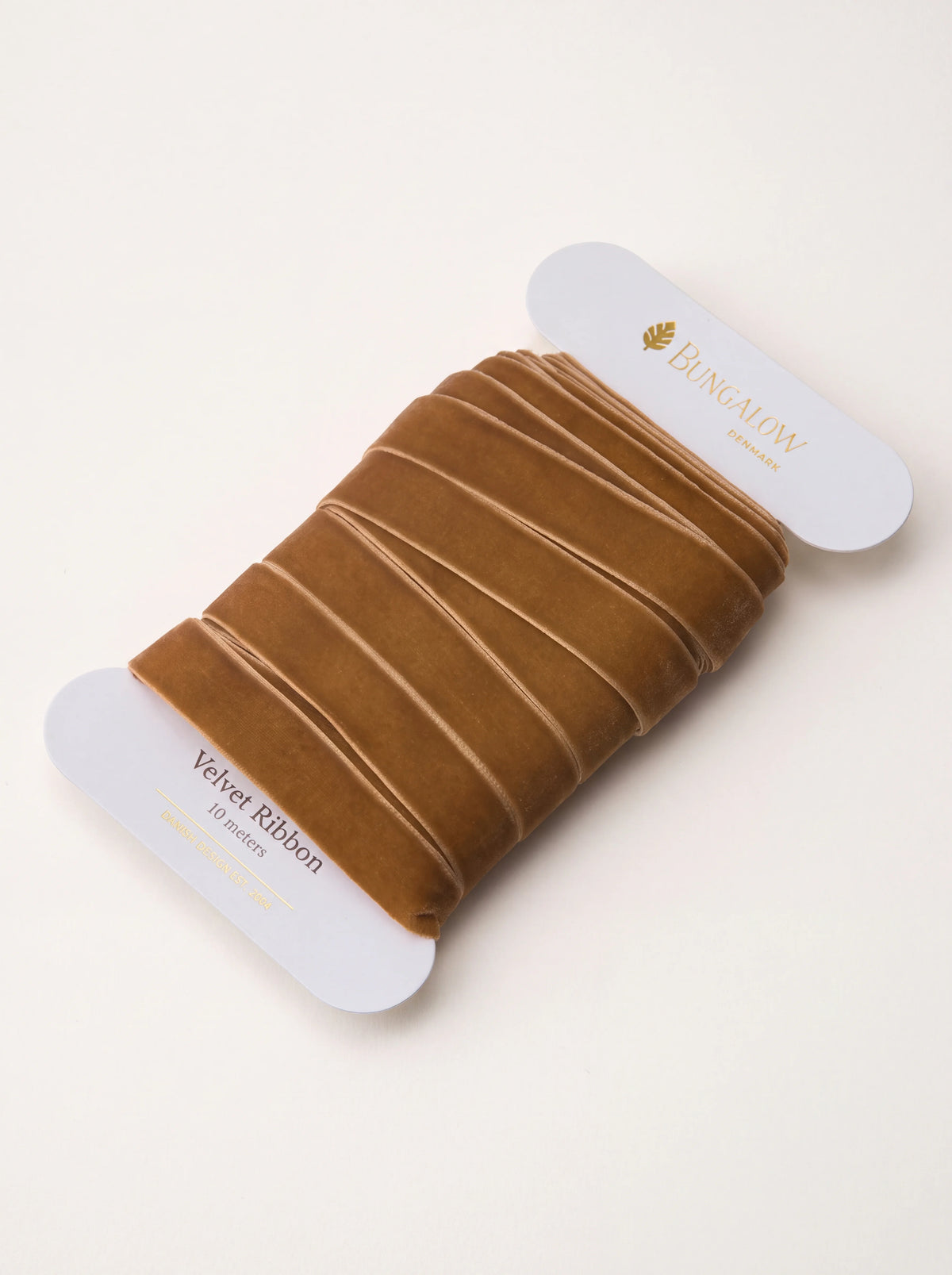 Caramel brown velvet ribbon wound on a white flat card spool labelled Velvet Ribbon 10 meters