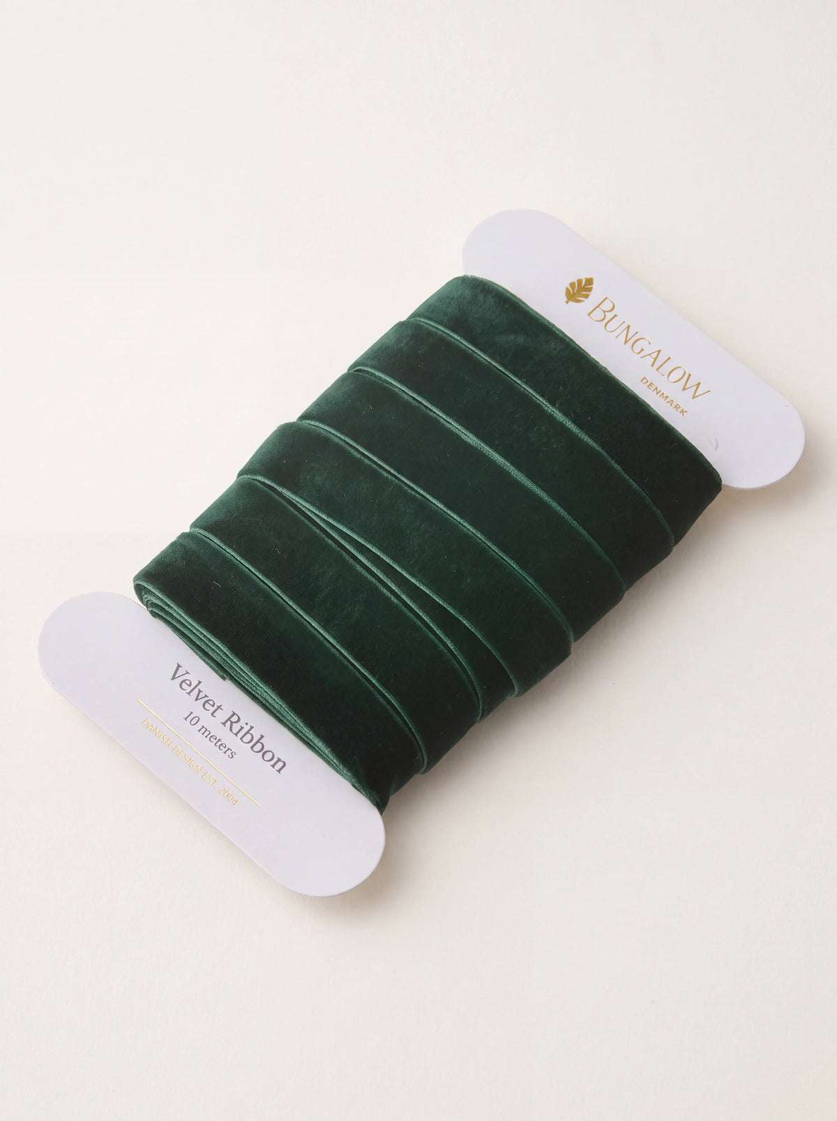 Dark green velvet ribbon wound on a white card spool labelled Velvet Ribbon 10 meters