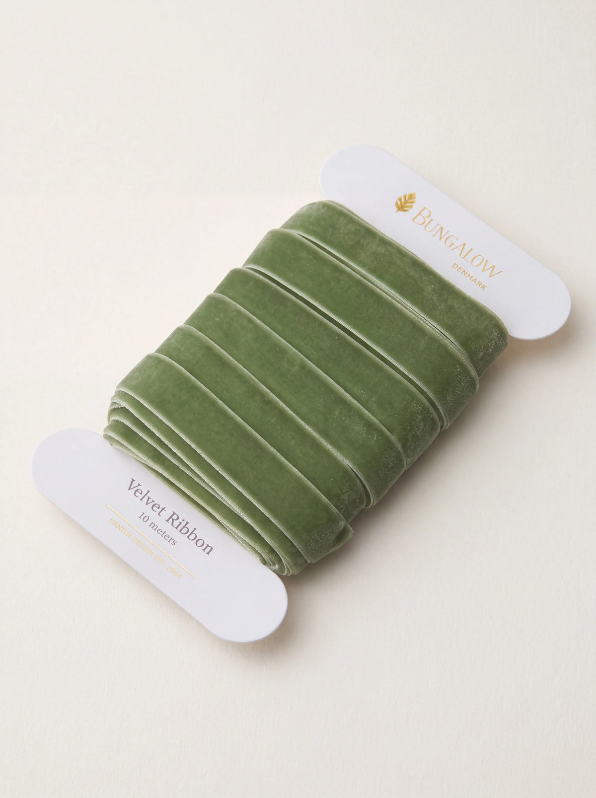 Moss green velvet ribbon wound around a white card spool labelled Velvet Ribbon 10 meters