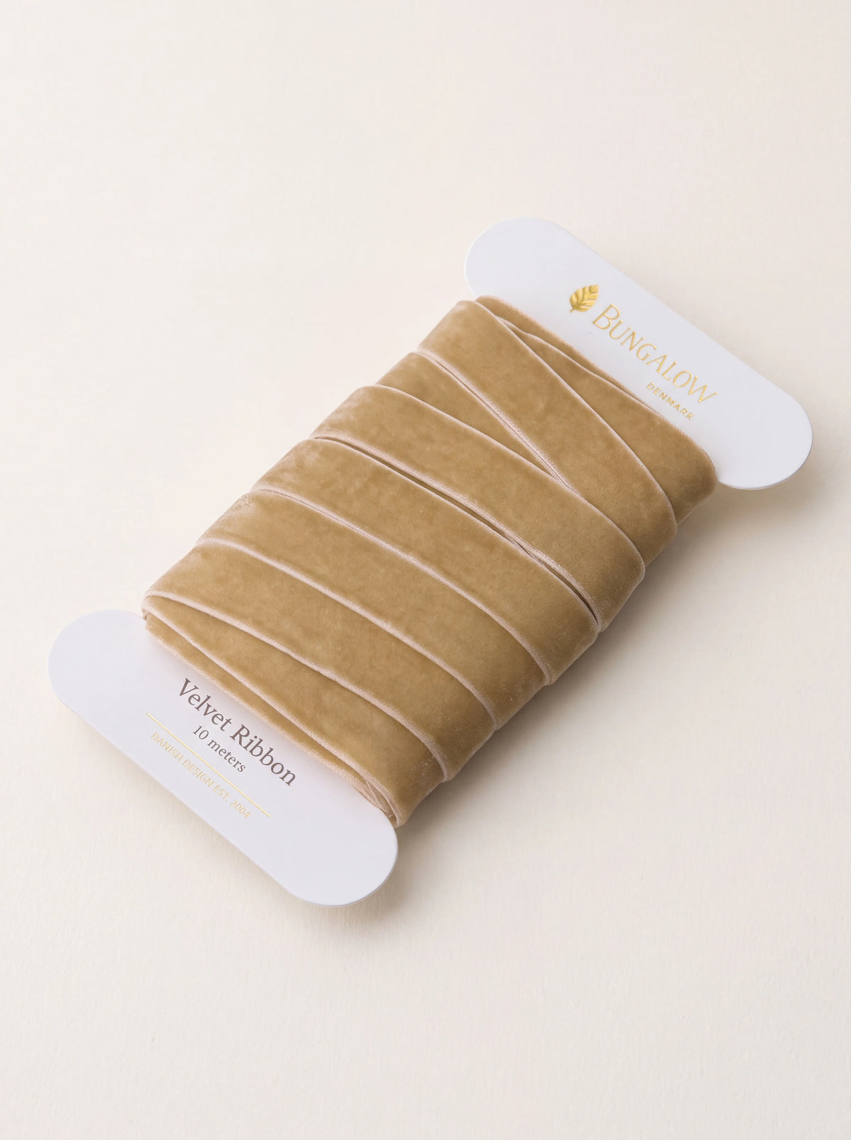 Sand-coloured velvet ribbon wound around a white card spool labeled Velvet Ribbon 10 meters