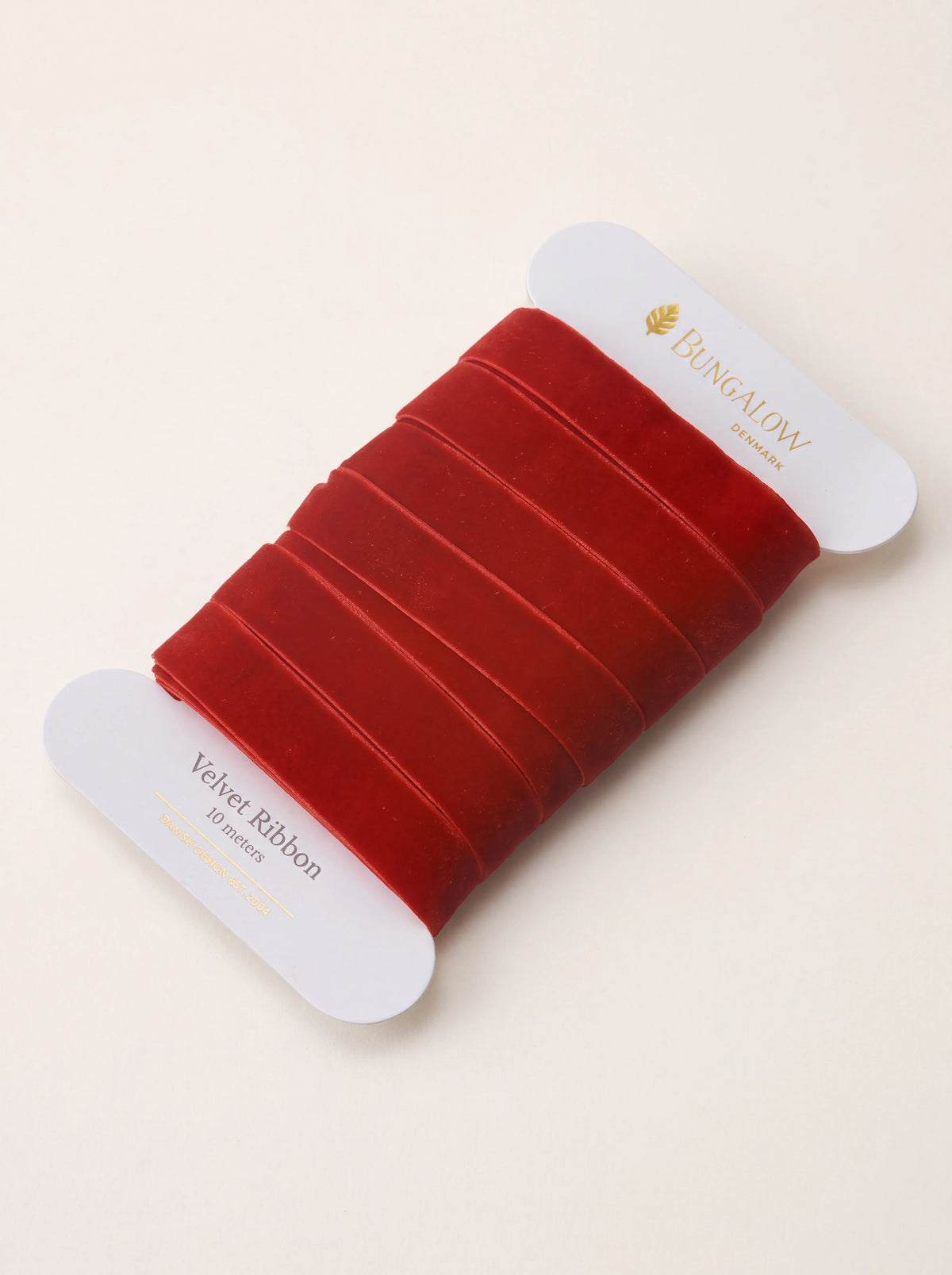 Scarlet velvet ribbon wound onto a white card labelled Velvet Ribbon 10 meters