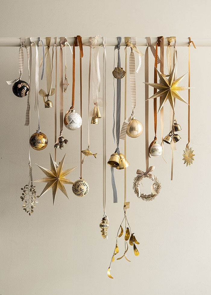 Striped ribbon used among other ribbons to hang festive baubles, stars and bells from a horizontal rail