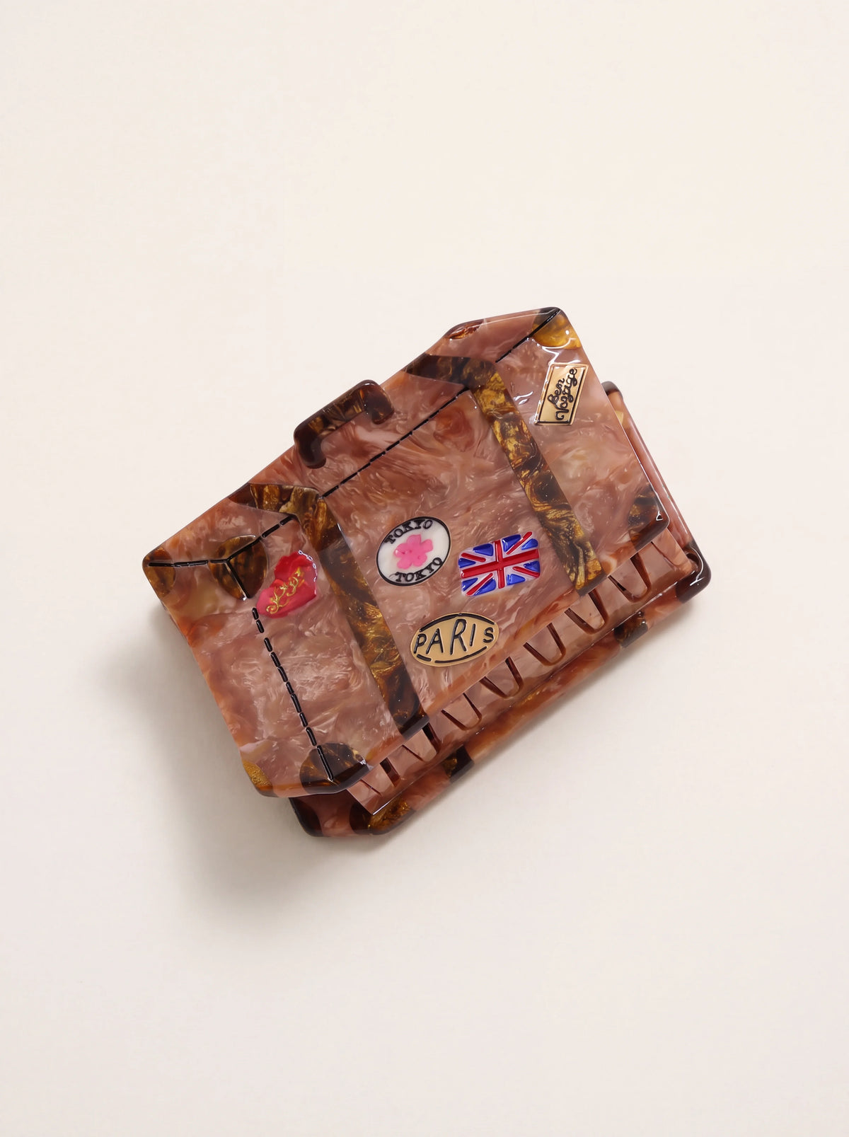 Vintage luggage hair clip in brown marbled acetate with travel motifs and interlocking teeth