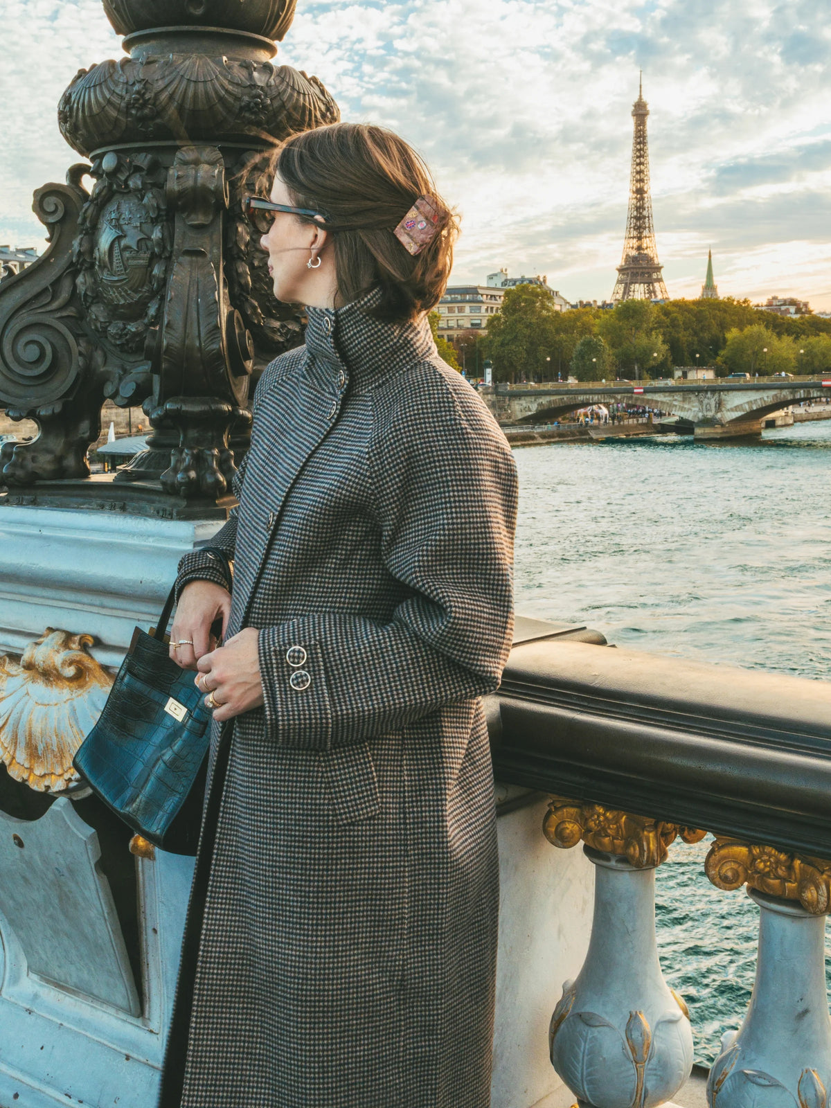 Vintage luggage hair clip shown in use securing hair in a half-up style