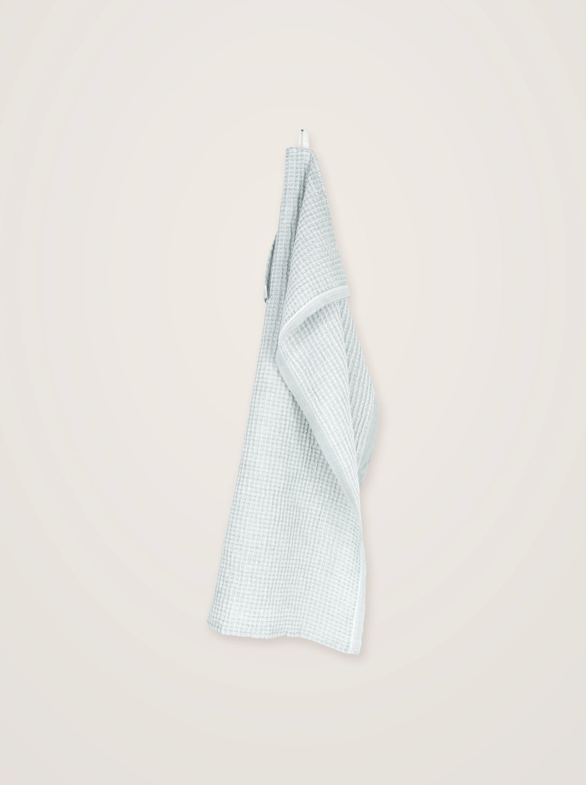 Waffle linen-blend towel in pale jade and white, hanging lengthwise by its integrated loop