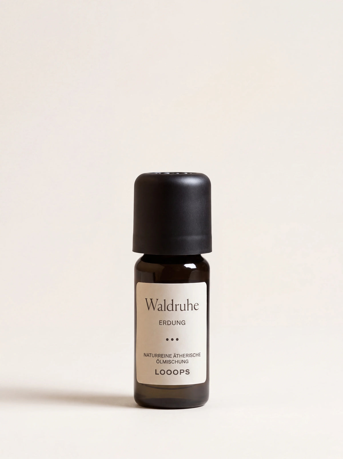 Waldruhe essential oil in a 10 ml amber glass dropper bottle with a matte black cap