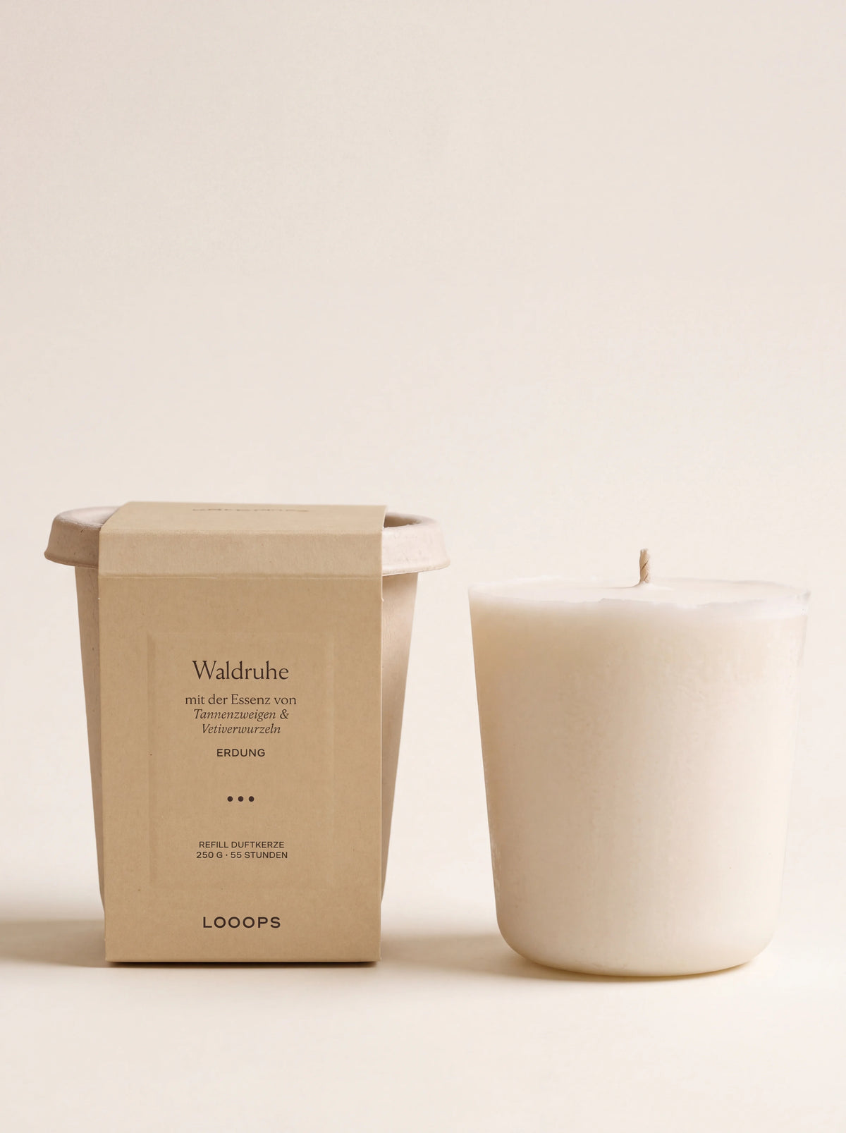 White vegetable wax scented candle refill beside its compostable bagasse cup and paper sleeve