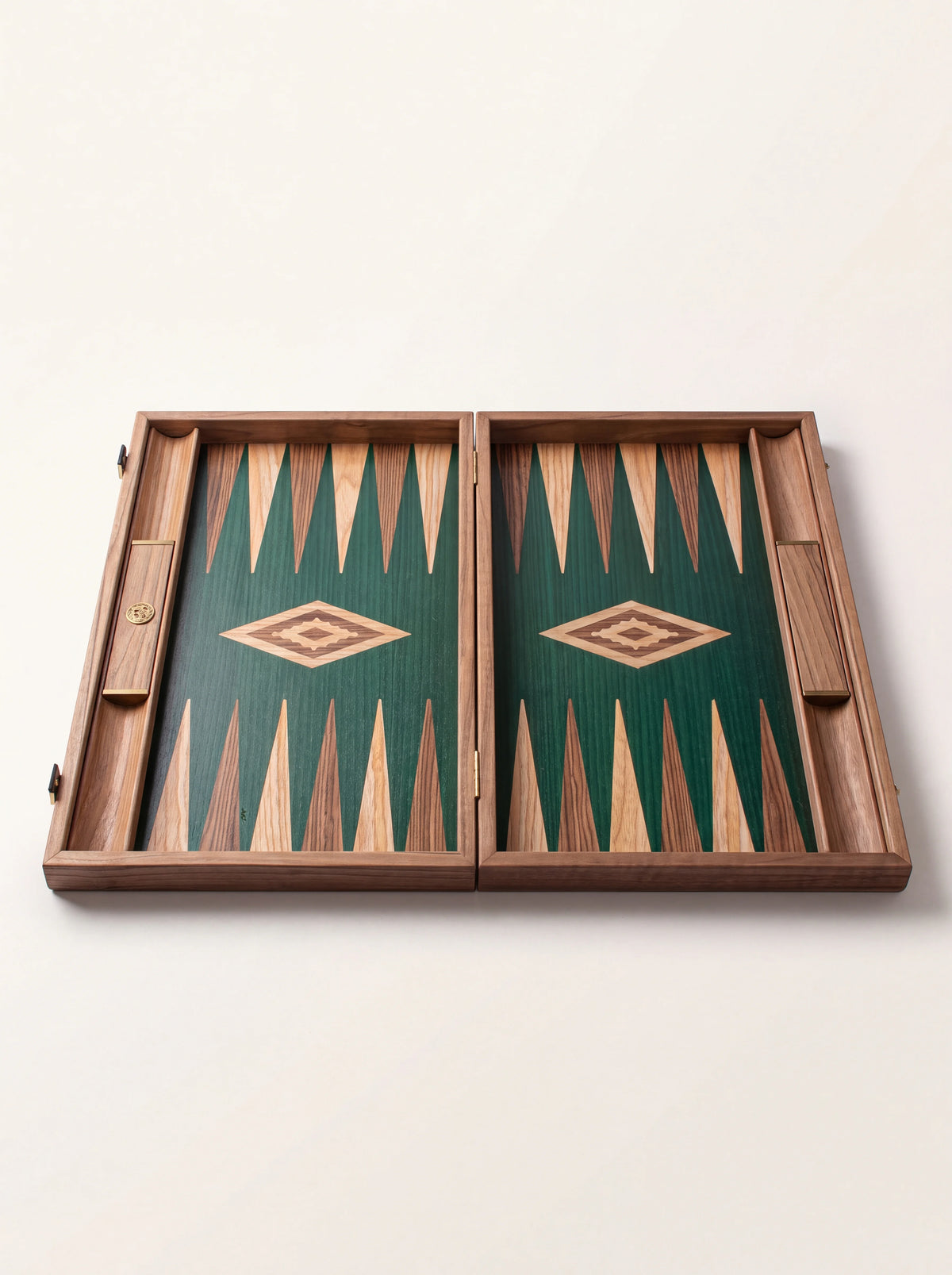 Empty open backgammon board showing the green oak surface, inlaid points and side storage racks