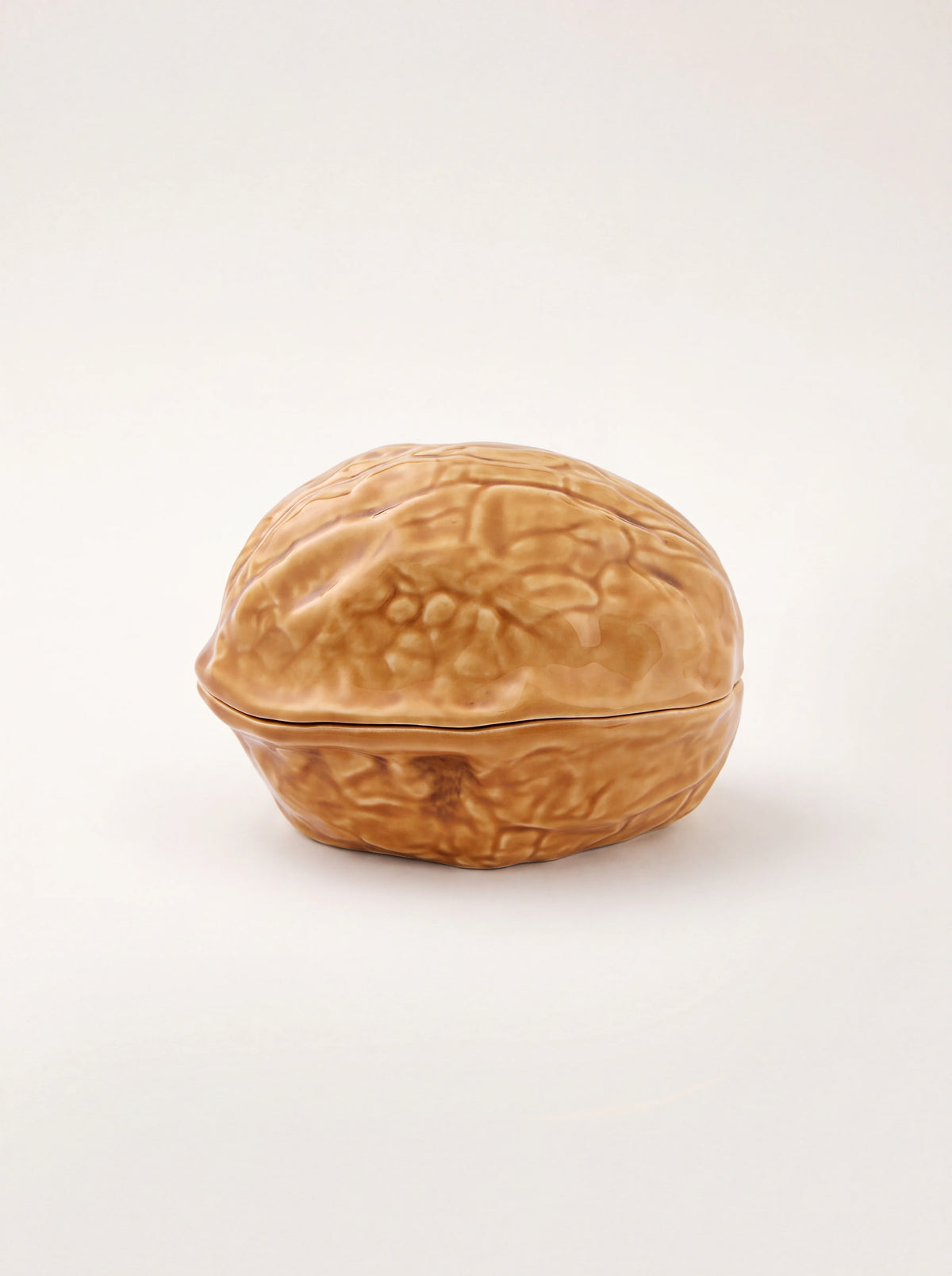 Walnut-shaped glazed earthenware box in light brown with a textured shell exterior and fitted lid