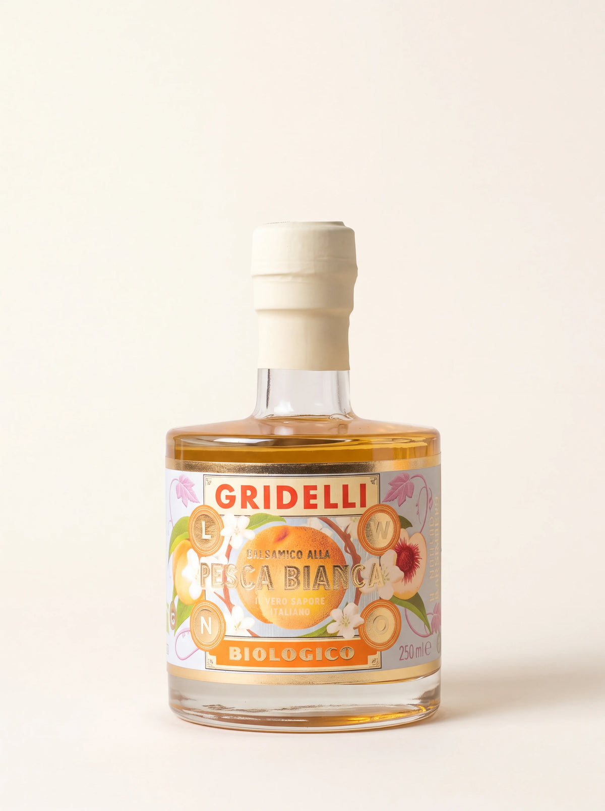 White peach balsamic vinegar in a 250 ml glass bottle with a cream sealed cap and Gridelli Pesca Bianca label