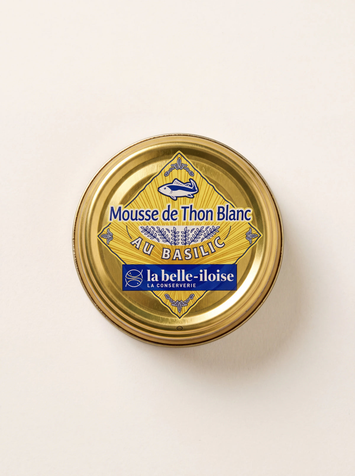 White tuna mousse in a round gold tin, labelled Mousse de Thon Blanc au Basilic