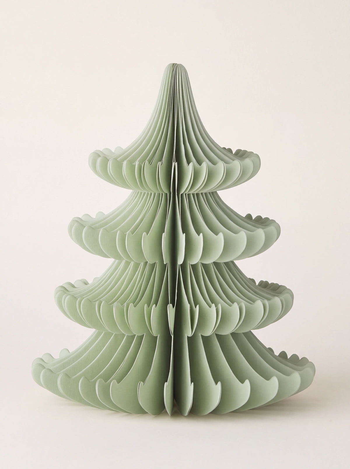 Tiered paper tree decoration in pale green with a folded honeycomb structure