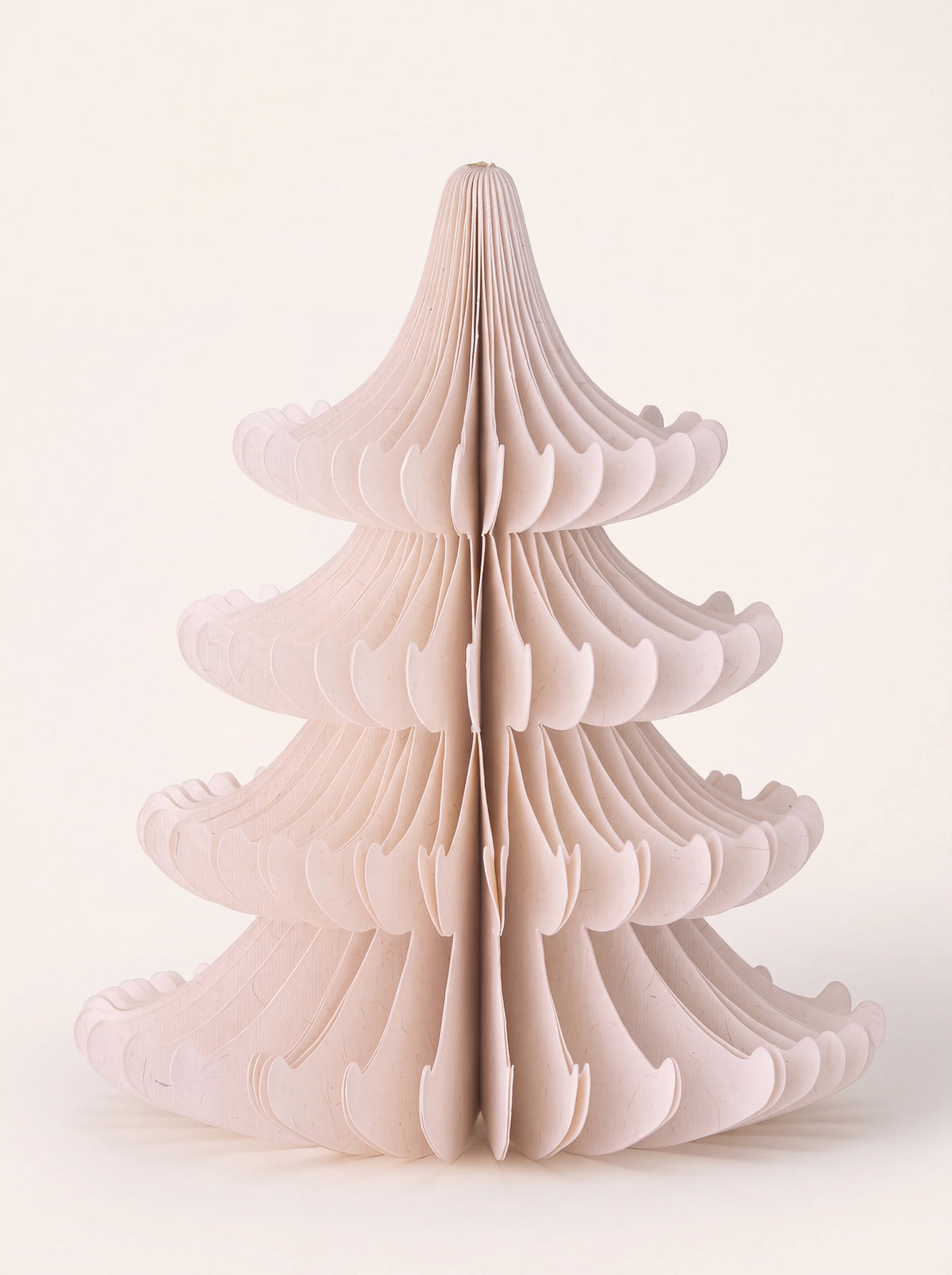 Tiered honeycomb paper tree decoration in powder pink with sculpted branches