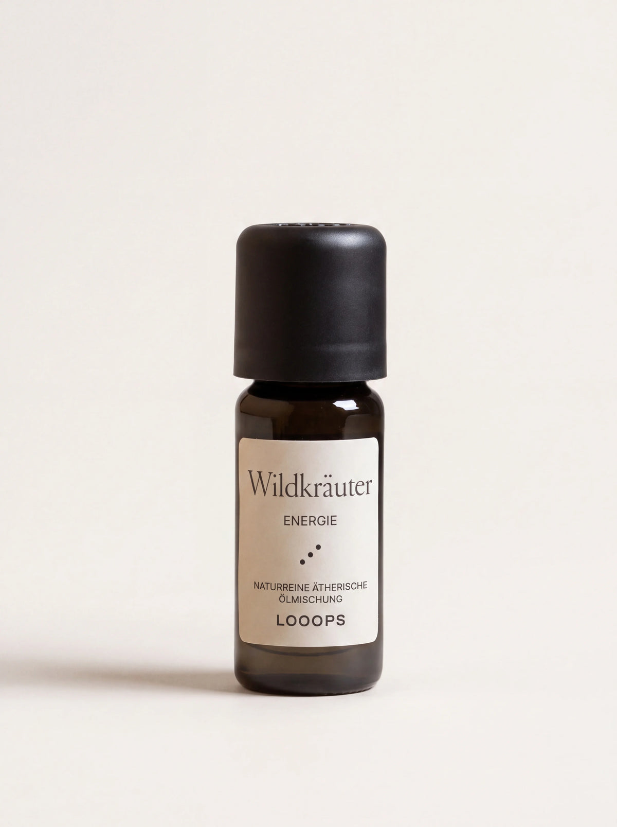 Wildkräuter essential oil in an amber glass bottle with a black screw cap and paper label