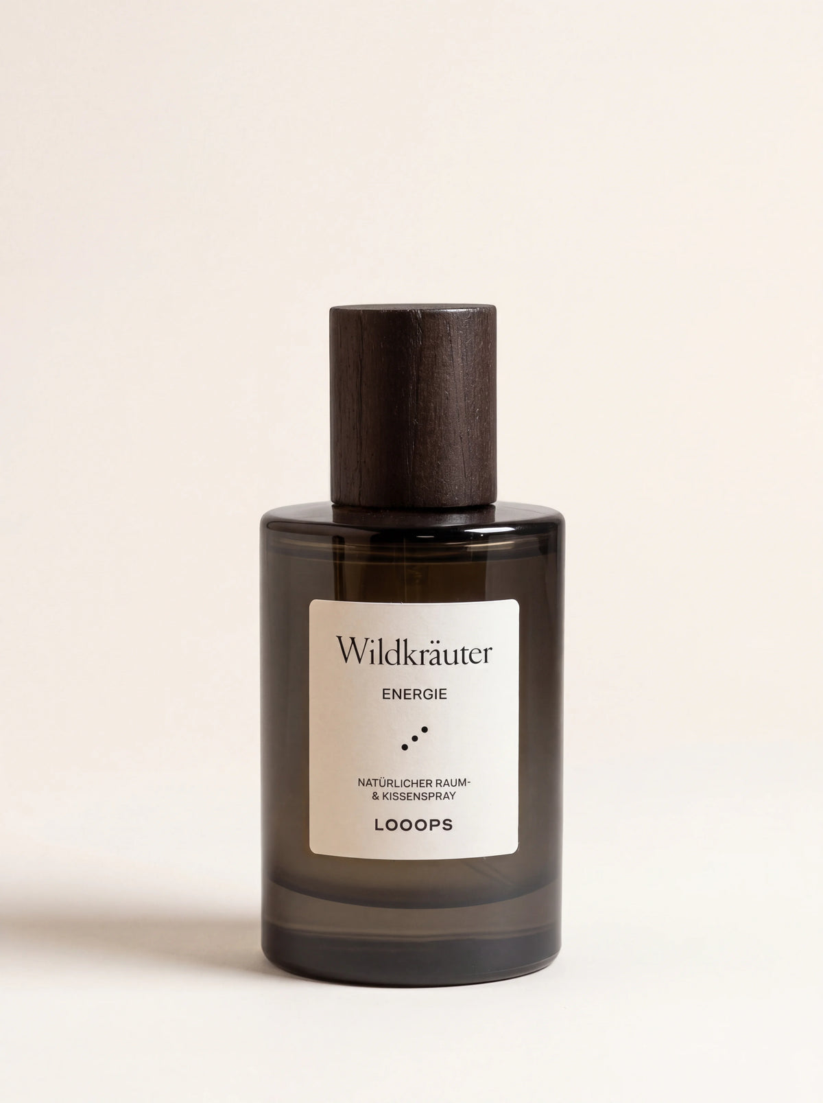 Wildkräuter room spray in a cylindrical dark glass bottle with a dark cork cap and white label