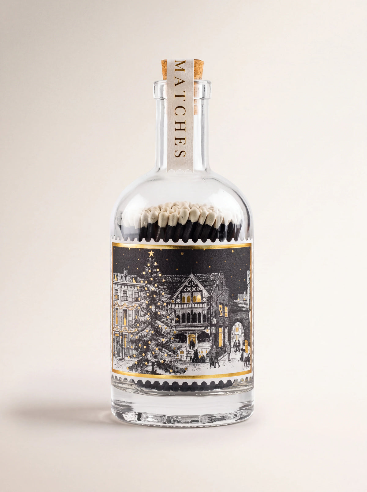 Glass match bottle with cork stopper, winter house illustration label, and vertical Matches neck seal