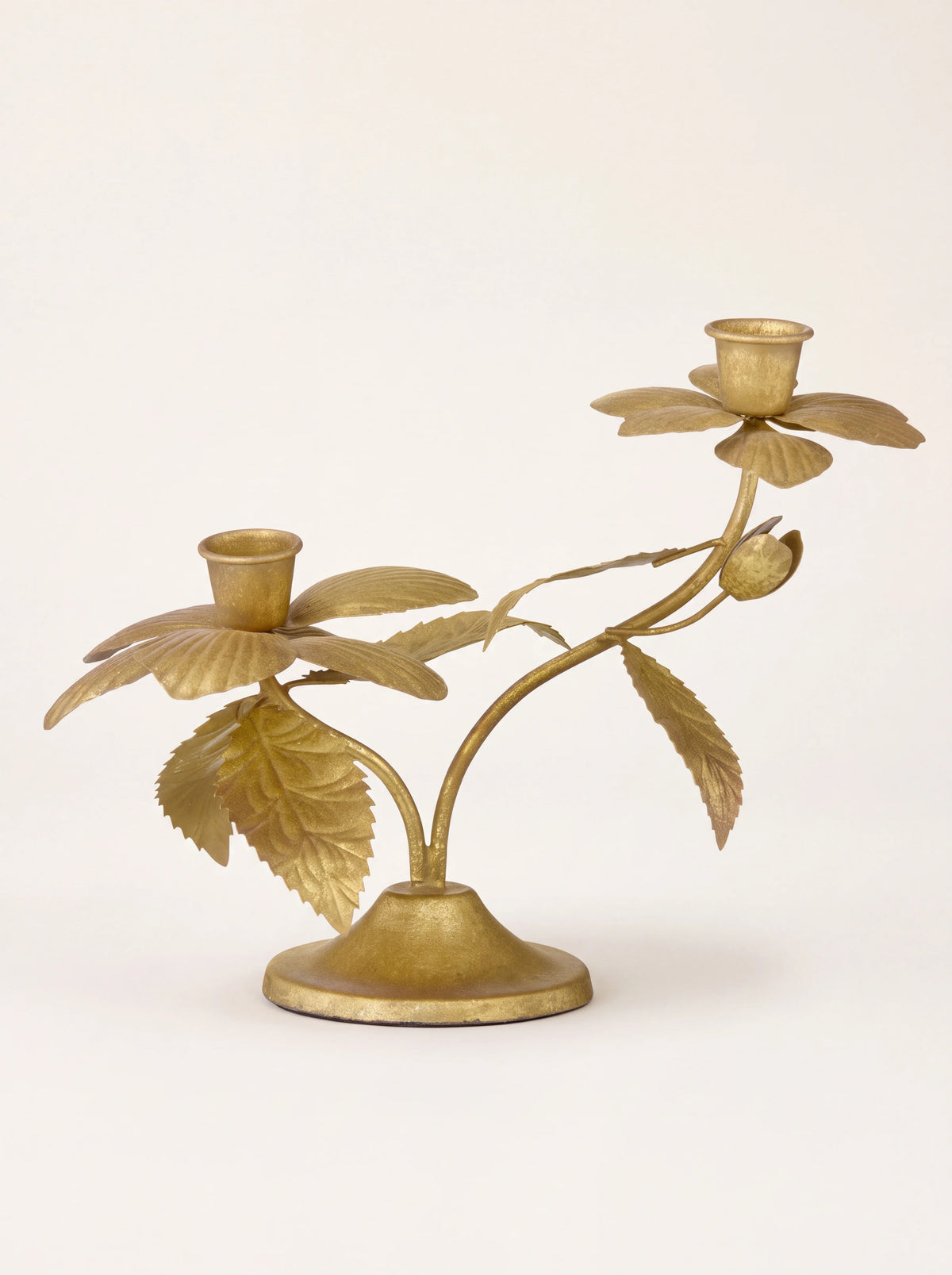 Golden metal candle holder with two flower-shaped cups on curved leafy branches