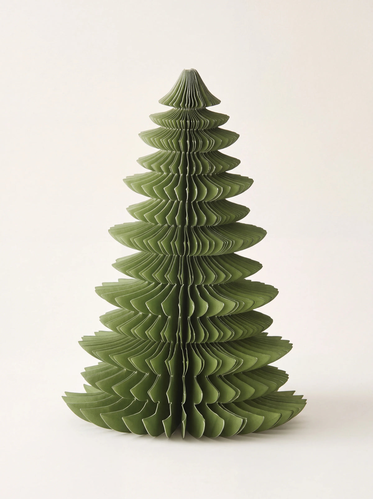 Green paper Christmas tree with a tiered honeycomb design, standing unfolded